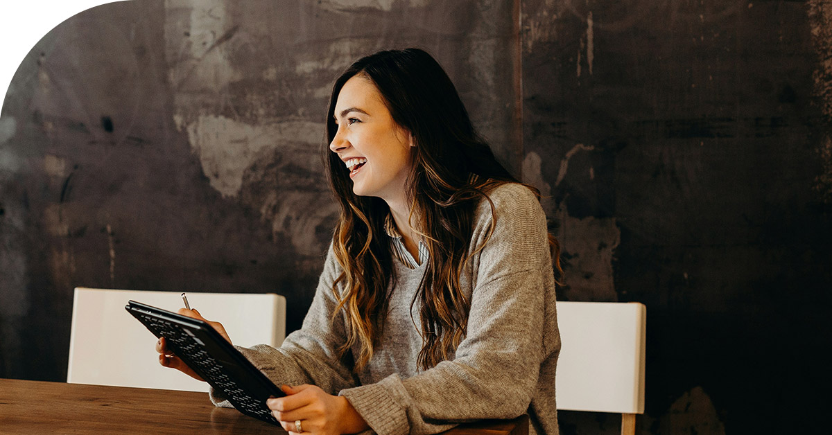 woman sitting at table smiling