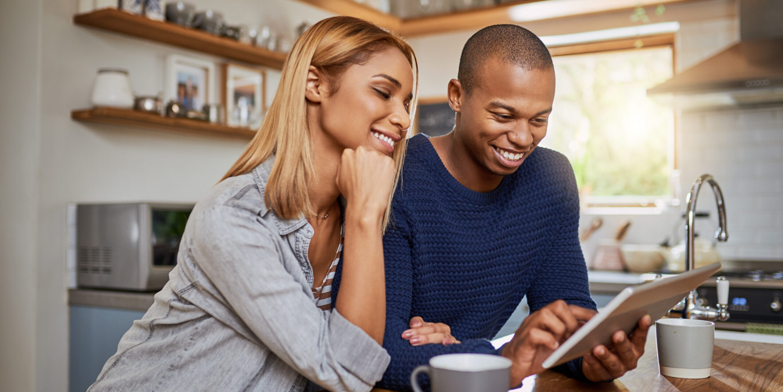 Cropped shot of a young couple using a digital tablet together at home