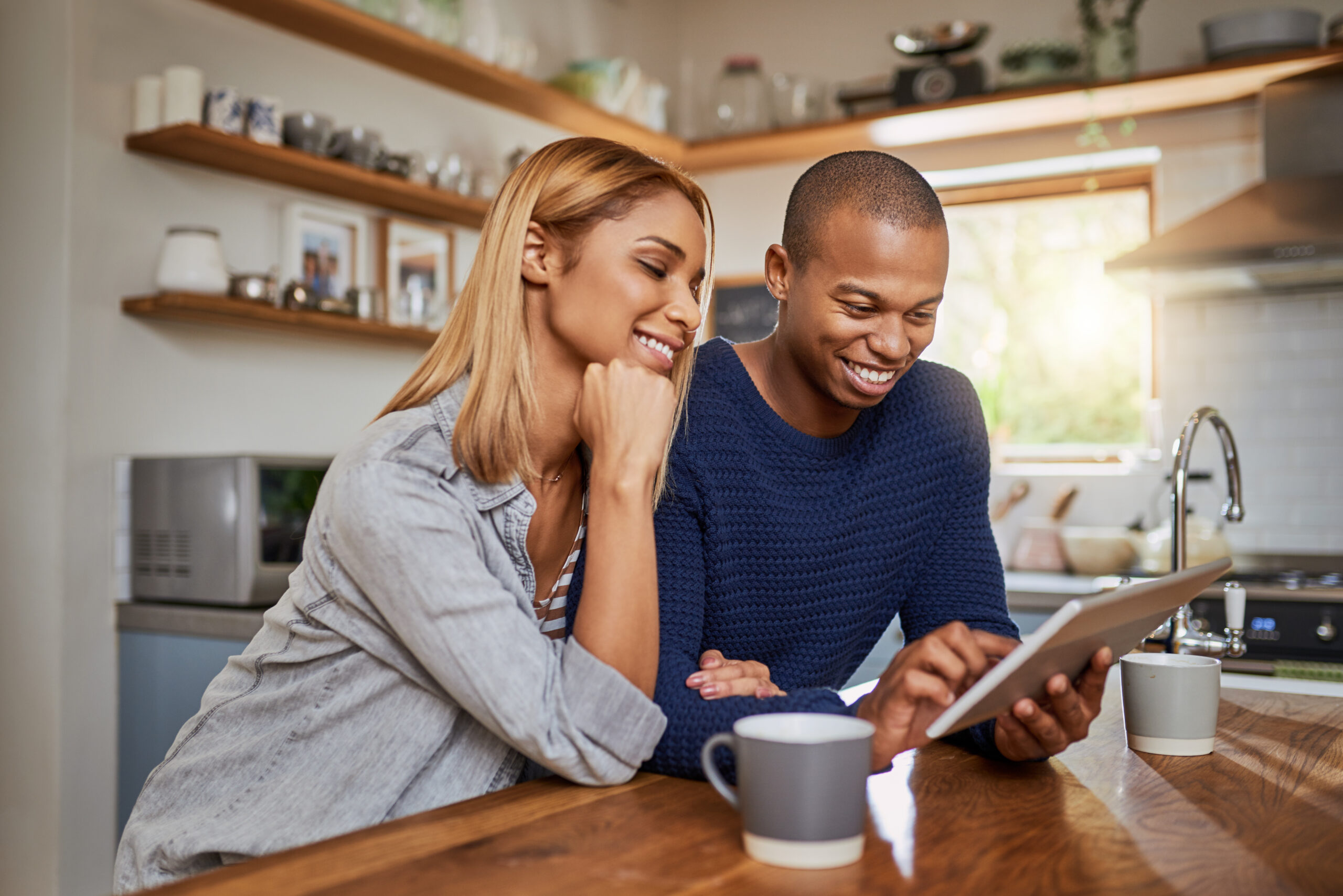 Cropped shot of a young couple using a digital tablet together at home